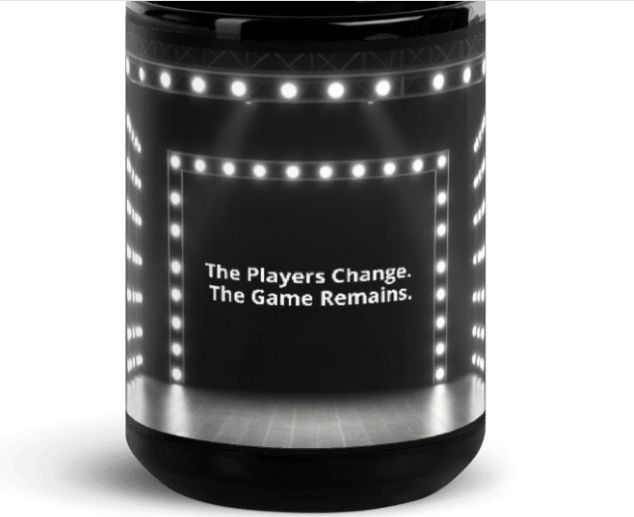 Black mug with a lit marquee stage reading The Players Change. The Game Remains.